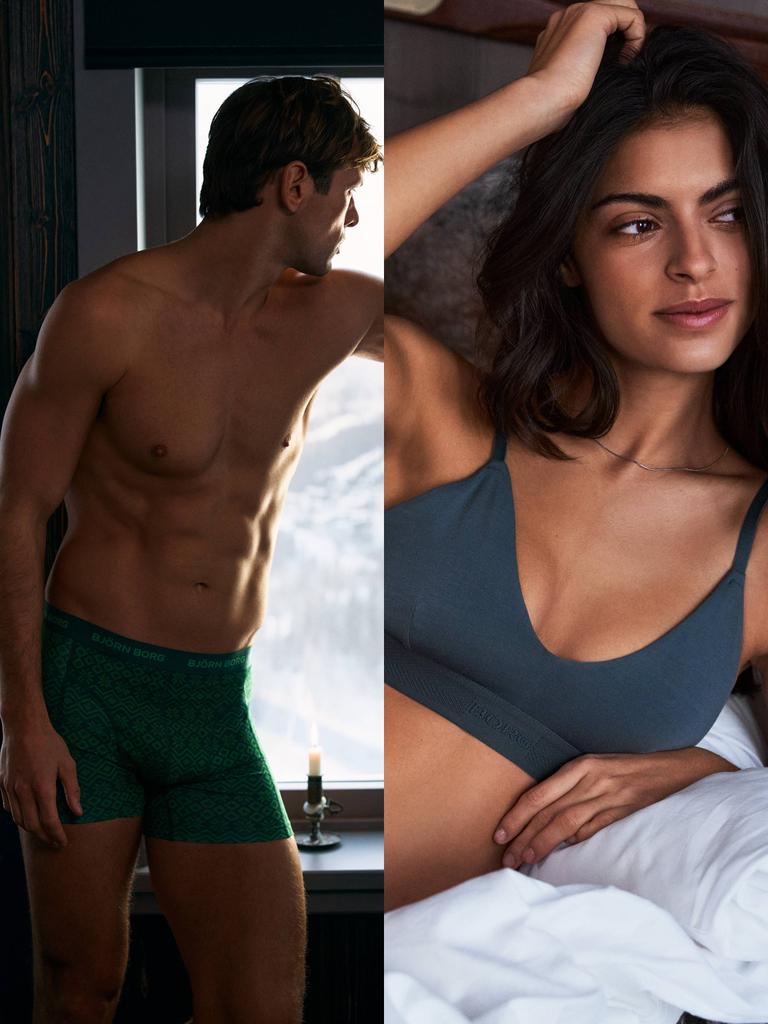 Man in green patterned underwear and woman in grey seamless underwear indoors.