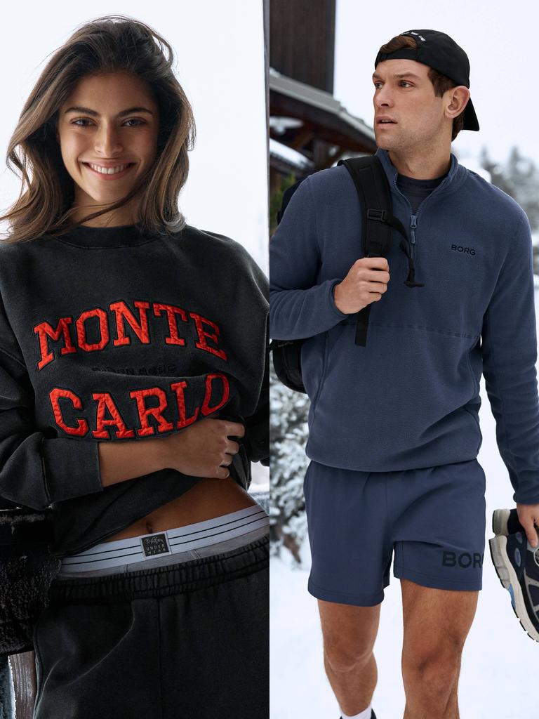 Woman in Monte Carlo sweatshirt and man in navy fleece outdoors in snow.